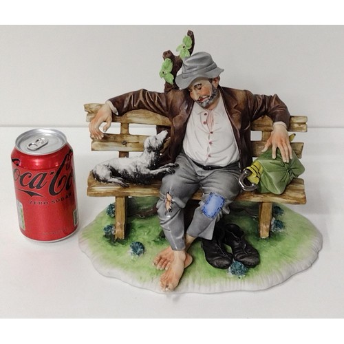 260 - Capodimonte figure of a Tramp on Bench with Dog, signed Tori Cigano. Shipping Group (A).