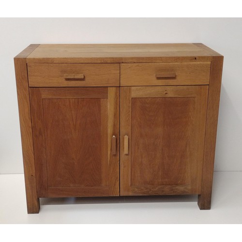 280 - Contemporary light oak cupboard having 2 drawers over 2 lower doors, opening to reveal cupboard spac... 