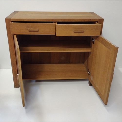 280 - Contemporary light oak cupboard having 2 drawers over 2 lower doors, opening to reveal cupboard spac... 