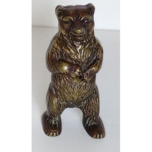 299 - Metal money box in the form of a standing bear, H:15 cm. Shipping Group (A).