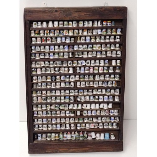 316 - Over (200) collectable thimbles in large display case measuring H:72 x W:48 cm. Collection only.