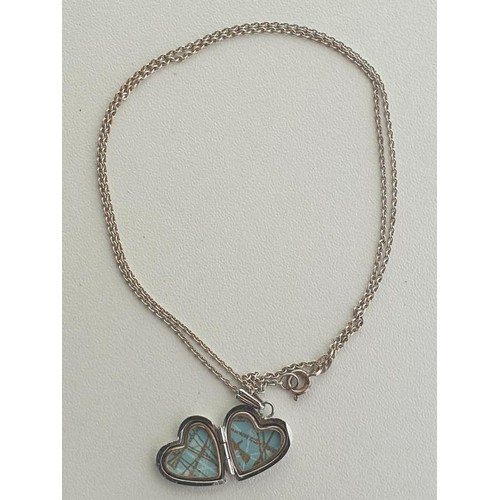 27 - Silver heart-shaped locket on chain. Shipping Group (A).