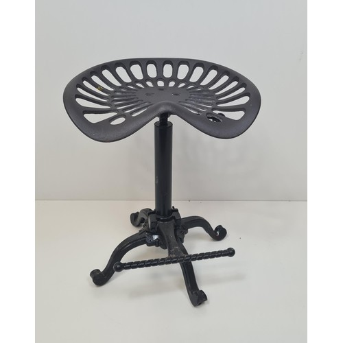 366 - Height adjustable cast metal stool having tractor seat and foot rest. Collection only.