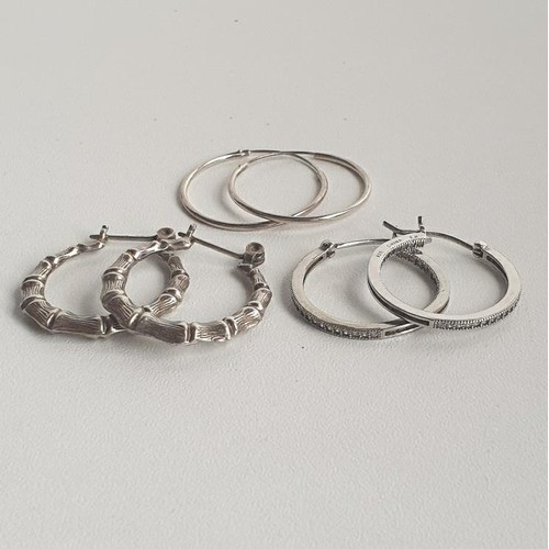 2 - 3 pairs of silver hoop earrings. Shipping Group (A).