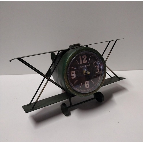 141 - Desk clock in the form of a bi-plane. Measuring  31cm overall width. Collection only.