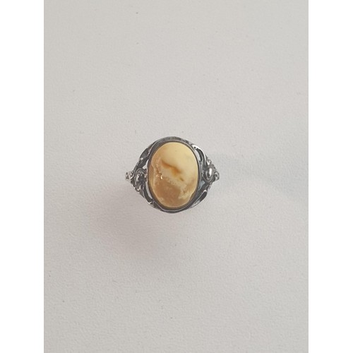 26 - Silver and butterscotch amber set ring, size N½. Shipping Group (A).