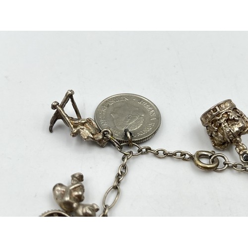 32 - Silver charm bracelet. Shipping Group (A).