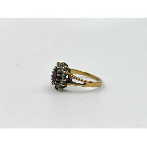 47 - 9ct gold garnet and cubic zirconia halo ring, size N. Shipping Group (A).