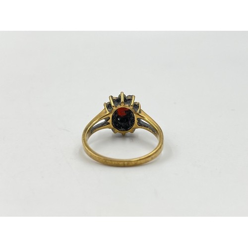 47 - 9ct gold garnet and cubic zirconia halo ring, size N. Shipping Group (A).