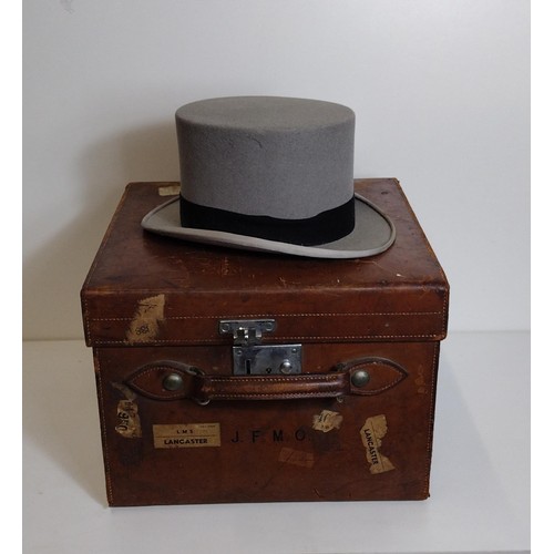 312 - An antique Harrod's leather hat box with a grey top hat. Shipping Group (B).