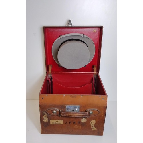 312 - An antique Harrod's leather hat box with a grey top hat. Shipping Group (B).