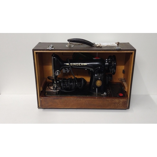 353 - Vintage Singer sewing machine in original wooden carry case. Collection only.