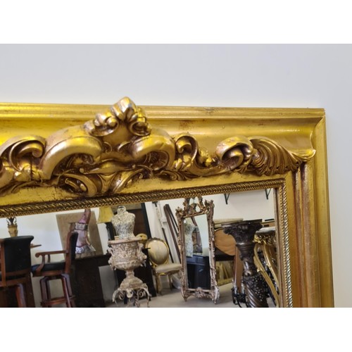 5 - A large gilt framed mirror measuring 107 (h) x 87 (w) cm.