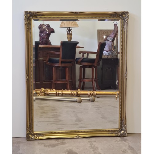 8 - A large French style bevel edged mirror in gilt frame measuring 132 (h) x 106 (w) cm.