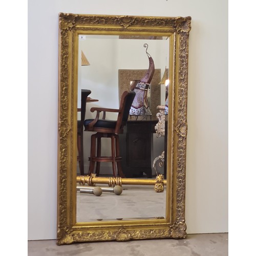 9 - A tall gilt framed and bevelled edge mirror of French style measuring 148 (h) x 85 (w) cm.