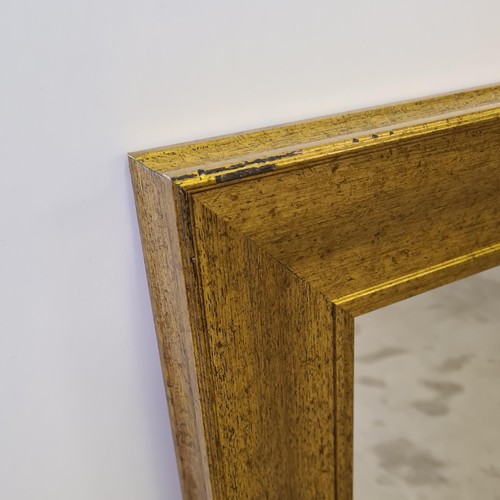 10 - A tall gilt framed and bevelled edge mirror of French style measuring 148 (h) x 85 (w) cm.