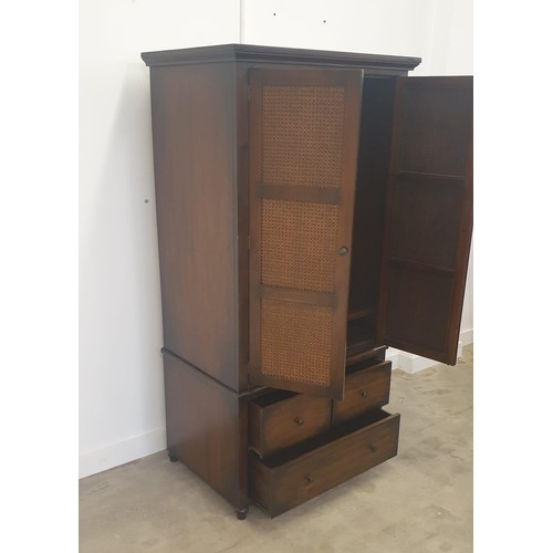 15 - A modern double wardrobe having 2 doors featuring cane effect inset panels., above 2 short and 1 lon... 