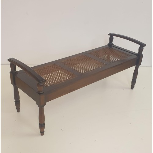 17 - Mahogany and cane bench, having 3 inset split-cane bergère seats in mahogany frame and raised on tur... 