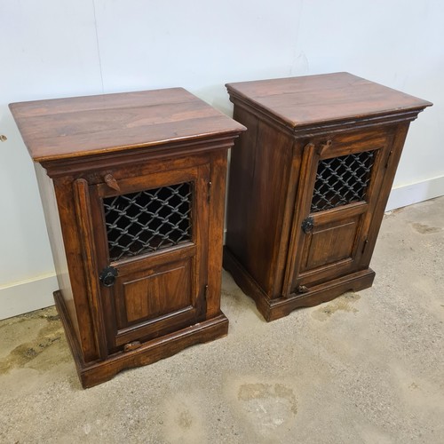 18 - A pair of Jali Sheesham and ironwork bedside cabinets, in colonial-style, having wrought iron p... 