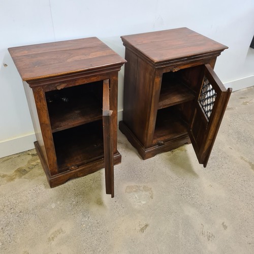 18 - A pair of Jali Sheesham and ironwork bedside cabinets, in colonial-style, having wrought iron p... 