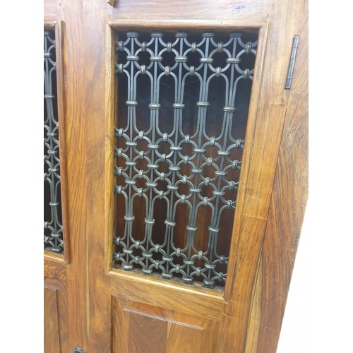 19 - Jali Sheesham and ironwork double wardrobe, in colonial-style, having wrought iron portcullis w... 