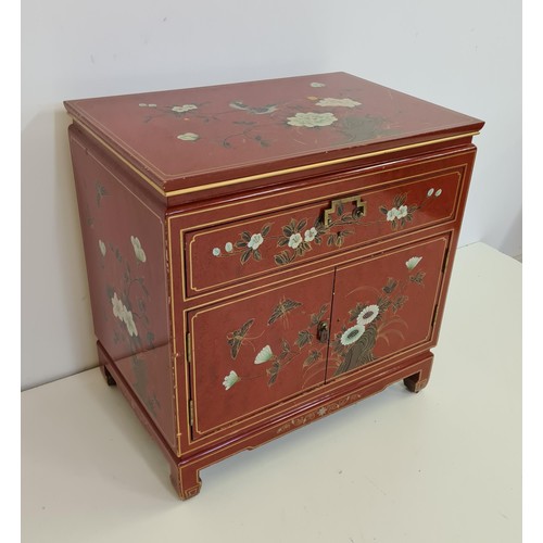 24 - An Oriental red lacquered cabinet measuring  62 (h) x 61 (w) x 41 (d).