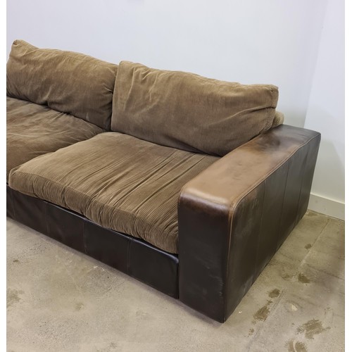 27 - A large brown leather four-seater sofa with loose corduroy seats and back supports. 45 (floor to sea... 