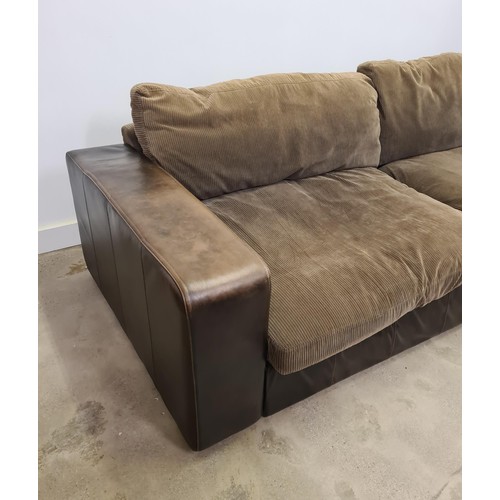 27 - A large brown leather four-seater sofa with loose corduroy seats and back supports. 45 (floor to sea... 