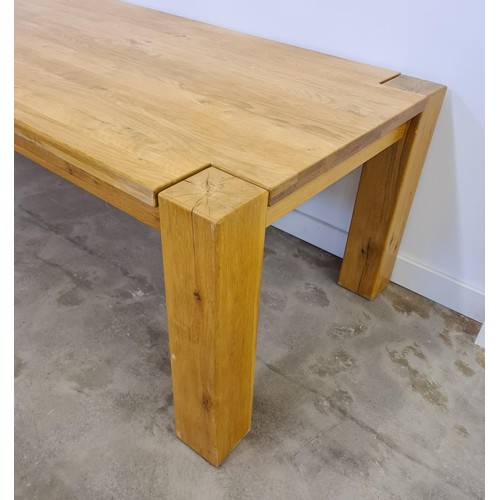 38 - A substantial oak dining table 75 (h) x 220 (w) x 101 (d) cm.