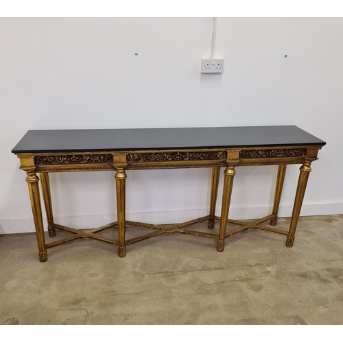 50 - A long French style console table having black marble top raised on gilt frame and reeded column leg... 