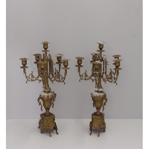 53 - A good pair of six-arm brass candelabras. 