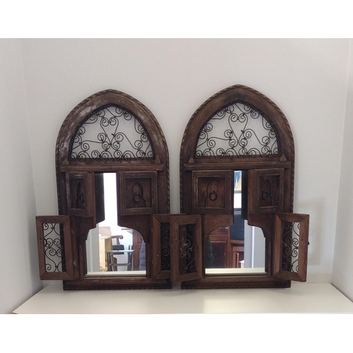 67 - A pair of decorative Moroccan wood and metal work wall mirrors.