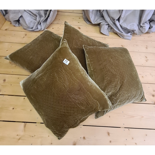 73 - Four large olive green cushions each measuring 64 x 64 cm.