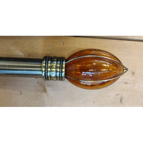 101 - Unusual metal curtain pole with orange blown-glass finials. 320 cm in length.