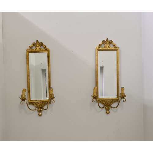 132 - A pair of twin-arm mirrored wall sconces. 65 (h) x 28 (w)