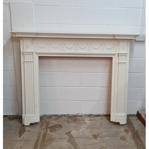 199 - An antique white painted wooden fire surround. 128 (h) x 169 (w) 19 (d).