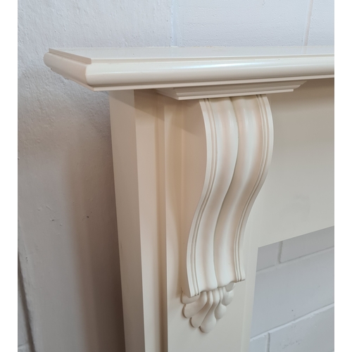 200 - An antique white painted wooden fire surround. 128 (h) x 155 (w) 23 (d).