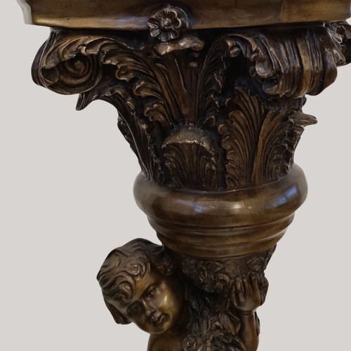 130 - A superb, tall and heavy Italian Gueridon in the form of a cherub supporting a pedestal.  Cast spelt... 