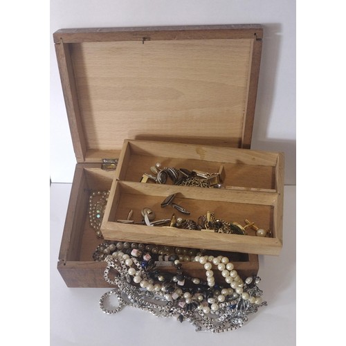 297 - A small wooden box of costume jewellery and cufflinks. Shipping Group (A).
