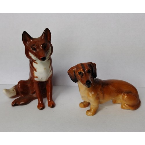 Beswick pottery small seated fox and a Royal Doulton dachshund
