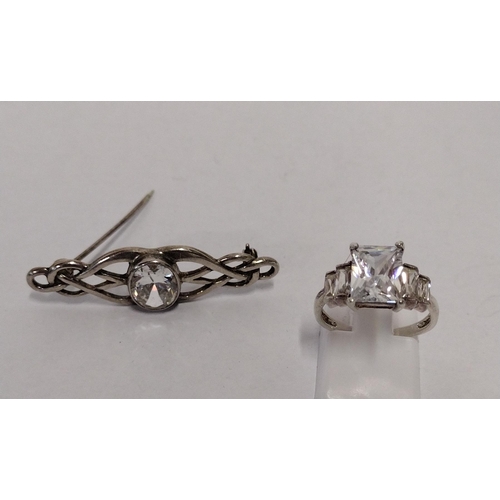 261 - 925 silver and clear stone set ring size L with clear stone set brooch. Shipping Group (A).