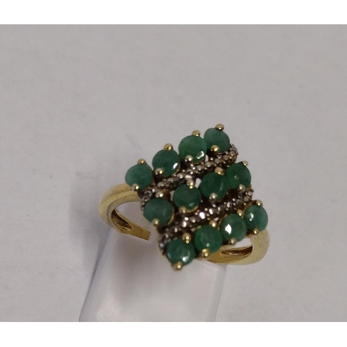 269 - 925 gold on silver ring set with twelve emeralds., size N. Shipping Group (A).