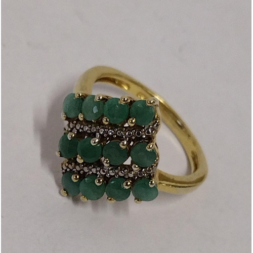 269 - 925 gold on silver ring set with twelve emeralds., size N. Shipping Group (A).