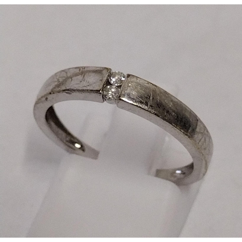 272 - 9ct white gold diamond two stone ring, size N½. Shipping Group (A).