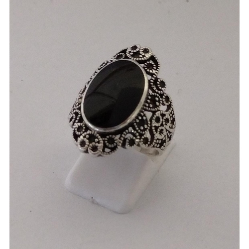 273 - 925 silver and black onyx set ring, size P½. Shipping Group (A).