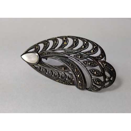 279 - White metal marcasite and mother of pearl brooch, 6cm, 14g. Shipping Group (A).