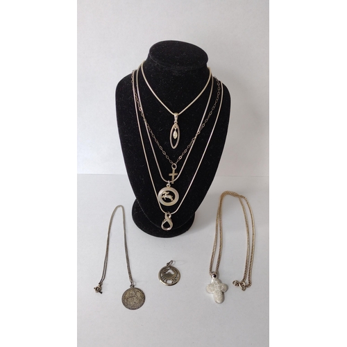 287 - Six silver necklaces and a pendant (stand not included). Shipping Group (A).