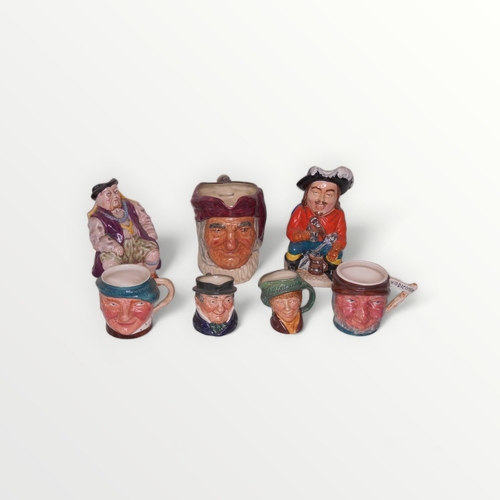 174 - A collection of pottery toby and character jugs to include a musical 'cavalier'.