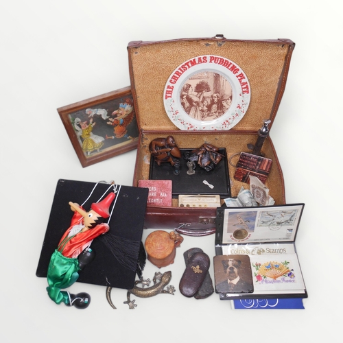 177 - A small tan pigskin suitcase of varied gentlemans collectables including carved wood, cast metal and... 