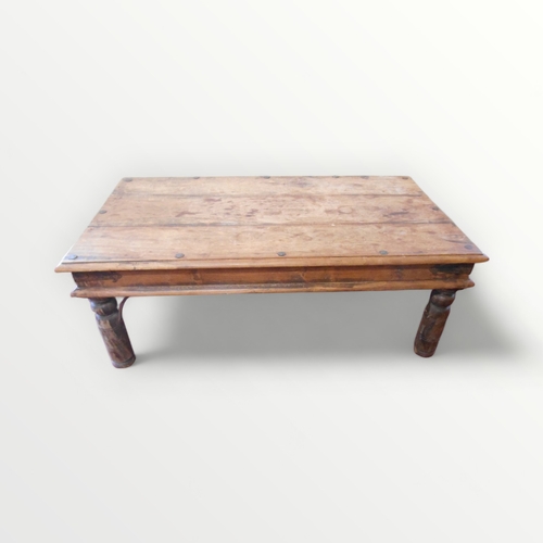 204 - An imported hardwood rectangular coffee table having decorative metalwork. 41 x 111 x 42cm.